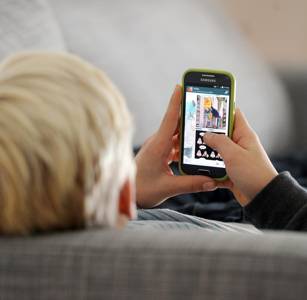 A young man surfing the Internet with a novice smartphone