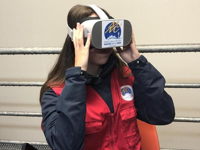 Justin Briswal, an intern at Maison de la Mer, tries to immerse herself in virtual reality on board 