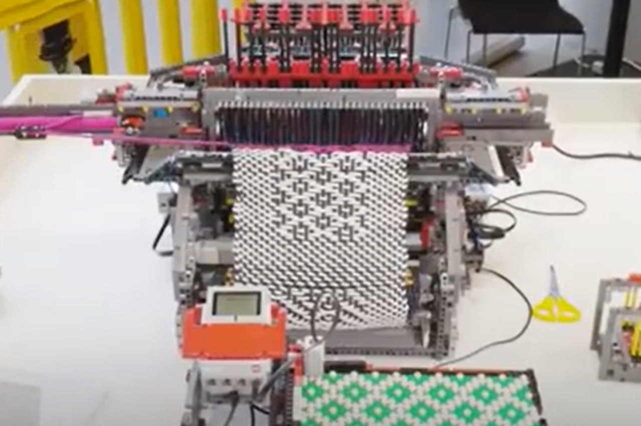 The frame is made entirely of Lego, which produces knitted scarves (almost) automatically