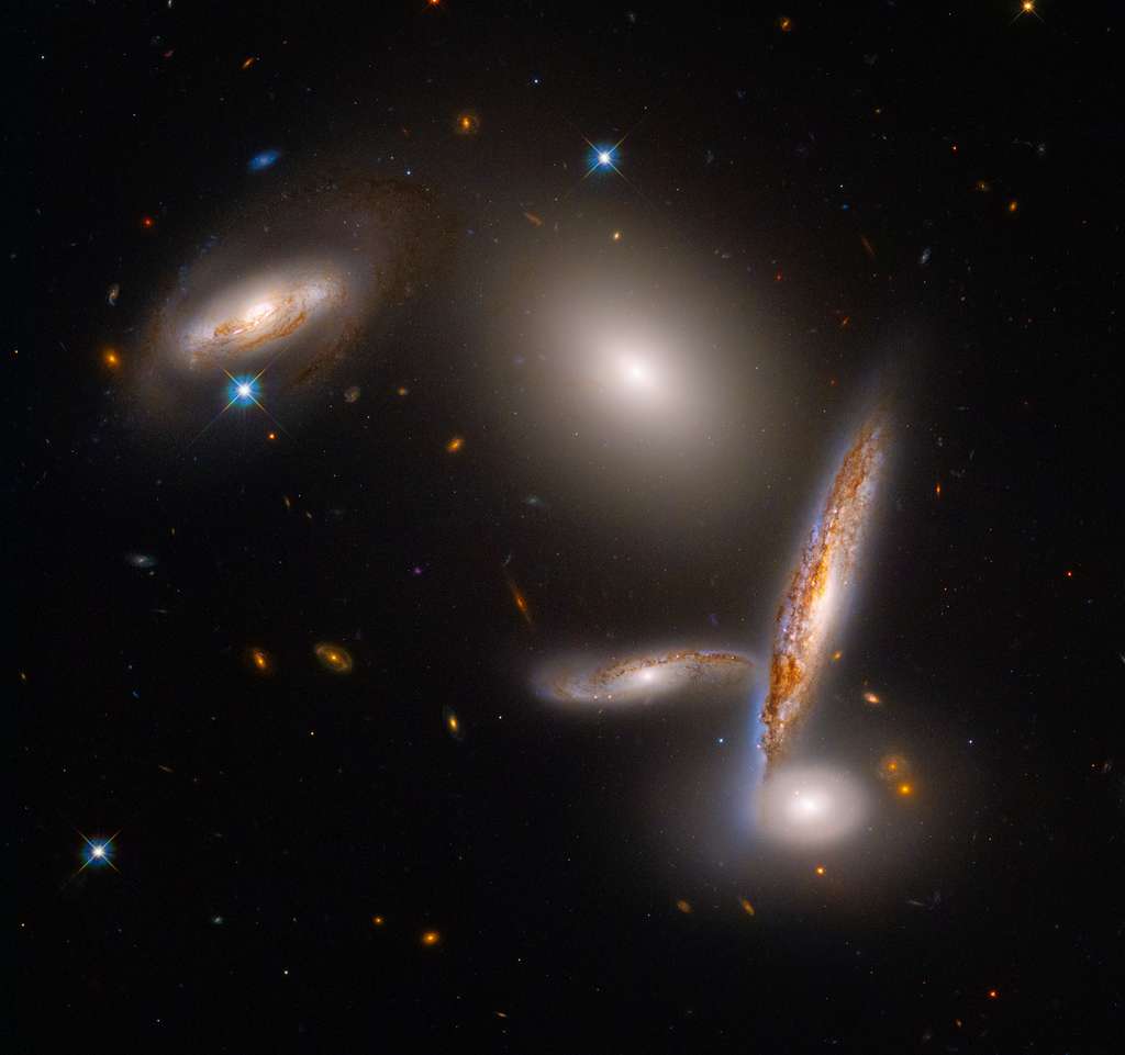 These five galaxies are trapped in a halo of dark matter that forces them closer to each other, until they collide.  Download the image for printing (28.6MB).  © NASA, ESA, STScI, Alyssa Pagan